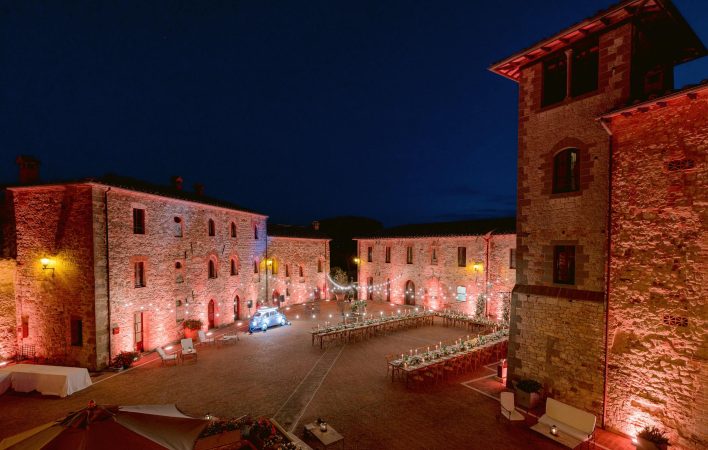 the courtyard of Castel Monastero at night for a wedding